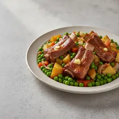 Costine con piselli e patate
