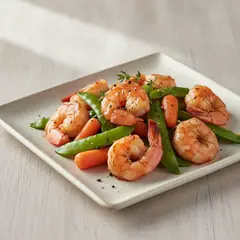 Gamberi saltati in salsa teriyaki con taccole e carotine