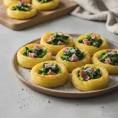 Nidi di patate duchessa con cime di rapa